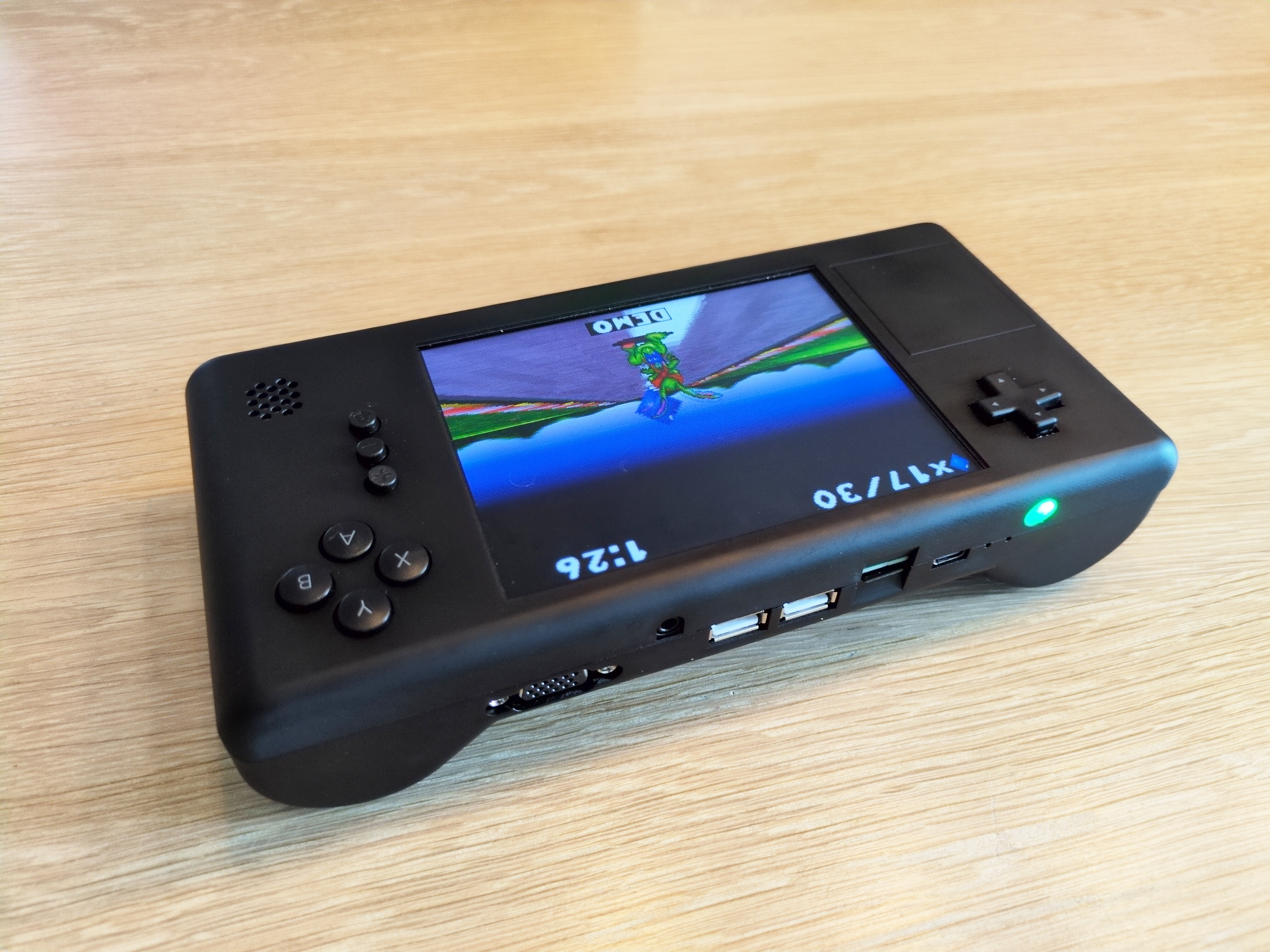 VapourDeck, isometric view from the back. Screen shows Jazz Jackrabbit, back has all the connectors: usb, audio, vga, usb-c, as well as the power button and micro-sdcard slot.